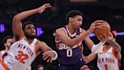 Apr 6, 2025; New York, New York, USA; Phoenix Suns forward Ryan Dunn (0) rebounds against New York Knicks center Karl-Anthony Towns (32) and guard Cameron Payne (1) during the first half at Madison Square Garden. Mandatory Credit: Vincent Carchietta-Imagn Images