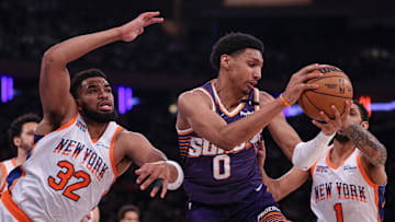 Apr 6, 2025; New York, New York, USA; Phoenix Suns forward Ryan Dunn (0) rebounds against New York Knicks center Karl-Anthony Towns (32) and guard Cameron Payne (1) during the first half at Madison Square Garden. Mandatory Credit: Vincent Carchietta-Imagn Images