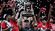 Sampson holds the trophy for winning the Midwest Regional surrounded by Cougars players.