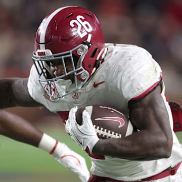 Alabama running back Jam Miller gets past Auburn safety Kaleb Harris in the Tide’s win.