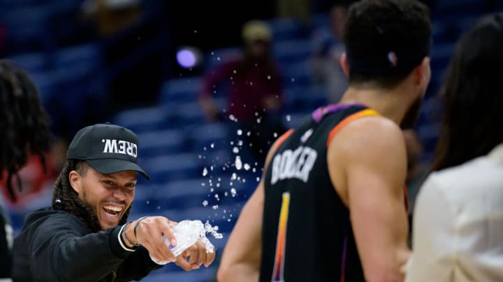 Apr 1, 2024; New Orleans, Louisiana, USA; Phoenix Suns guard Damion Lee, left, sprays his teammate