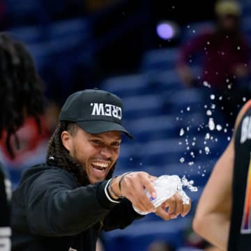 Apr 1, 2024; New Orleans, Louisiana, USA; Phoenix Suns guard Damion Lee, left, sprays his teammate Phoenix Suns guard Devin Booker (1) with water after the Suns defeated the New Orleans Pelicans at Smoothie King Center. Mandatory Credit: Matthew Hinton-USA TODAY Sports