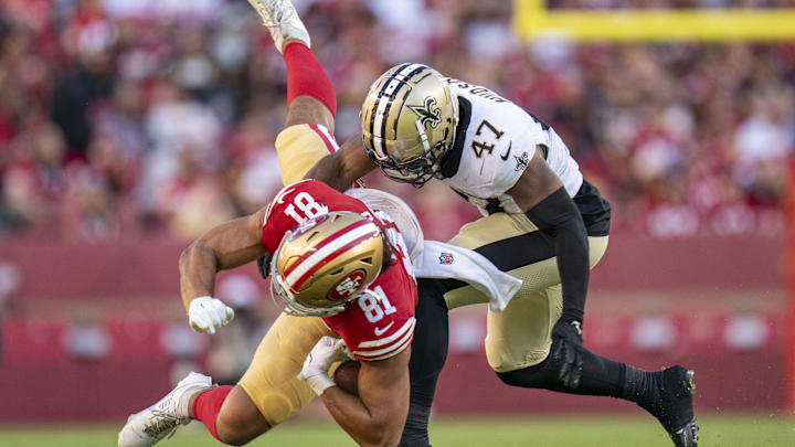 August 18, 2024; Santa Clara, California, USA; New Orleans Saints linebacker Khaleke Hudson (47) tackles San Francisco 49ers tight end Cameron Latu (81) during the third quarter at Levi's Stadium. Mandatory Credit: Kyle Terada-Imagn Images