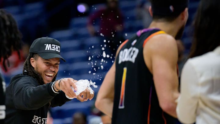 Apr 1, 2024; New Orleans, Louisiana, USA; Phoenix Suns guard Damion Lee, left, sprays his teammate