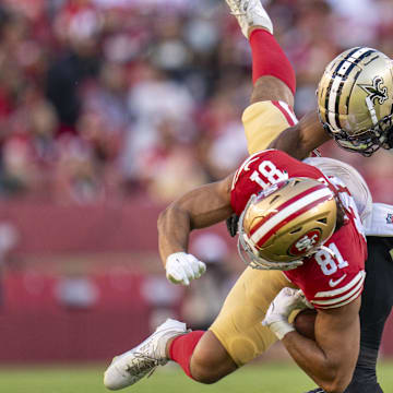 New Orleans Saints linebacker Khaleke Hudson (47) tackles San Francisco 49ers tight end Cameron Latu (81)