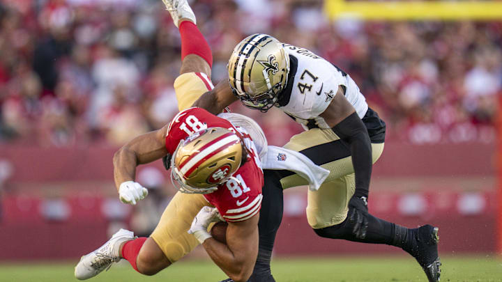 New Orleans Saints linebacker Khaleke Hudson (47) tackles San Francisco 49ers tight end Cameron Latu (81)