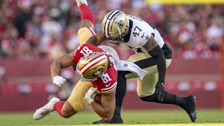 August 18, 2024; Santa Clara, California, USA; New Orleans Saints linebacker Khaleke Hudson (47) tackles San Francisco 49ers tight end Cameron Latu (81) during the third quarter at Levi's Stadium. Mandatory Credit: Kyle Terada-Imagn Images