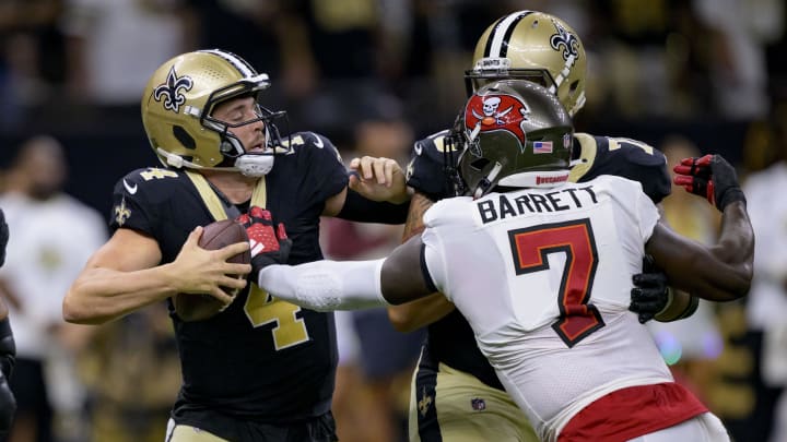 Oct 1, 2023; New Orleans, Louisiana, USA; New Orleans Saints quarterback Derek Carr (4) tries to escape the grasp of Tampa Bay Buccaneers linebacker Shaquil Barrett (7) during the first quarter at the Caesars Superdome. Mandatory Credit: Matthew Hinton-USA TODAY Sports