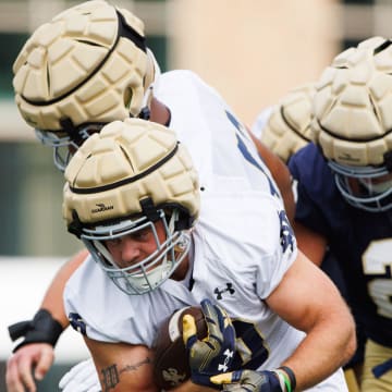 Notre Dame running back Aneyas Williams runs through a gap during a Notre Dame football practice at Irish Athletic Center on Thursday, Aug. 1, 2024, in South Bend.