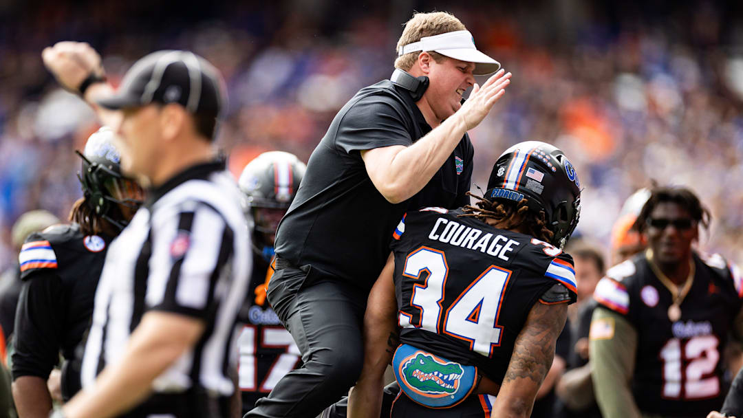 Florida Gators defensive coordinator Austin Armstrong celebrates with Florida Gators linebacker Mannie Nunnery (34) after a stop during the first half against the Arkansas Razorbacks at Steve Spurrier Field at Ben Hill Griffin Stadium in Gainesville, FL.
