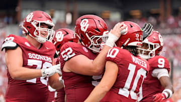 Oklahoma's John Mateer (10) celebrates his touchdown with Troy Everett (52)