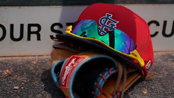 Mar 20, 2018; Jupiter, FL, USA; A St. Louis Cardinals hat with sunglasses sits on a glove in the dugout during a spring training game against the New York Mets at Roger Dean Stadium. Mandatory Credit: Jasen Vinlove-Imagn Images