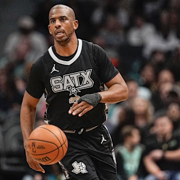 Feb 7, 2025; Charlotte, North Carolina, USA;  San Antonio Spurs guard Chris Paul (3) brings the ball up court against the Charlotte Hornets during the second half at Spectrum Center. Mandatory Credit: Jim Dedmon-Imagn Images