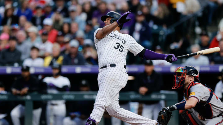 Aug 9, 2024; Denver, Colorado, USA; Colorado Rockies catcher Elias Diaz (35) hits an RBI double in the fourth inning against the Atlanta Braves at Coors Field.