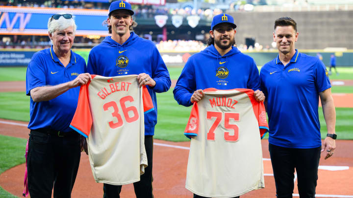 Seattle Mariners chairman John Stanton and president, of baseball operations Jerry Dipoto present all-star jerseys to pitchers Logan Gilbert (36) & Andres Munoz (75) before the game between the Seattle Mariners and the Houston Astros at T-Mobile Park in 2024.