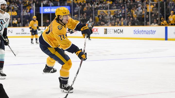 Mar 6, 2025; Nashville, Tennessee, USA;  Nashville Predators right wing Luke Evangelista (77) scores on an empty net shot against the Seattle Kraken during the third period at Bridgestone Arena. Mandatory Credit: Steve Roberts-Imagn Images
