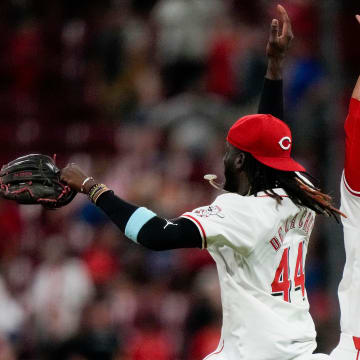 Cincinnati Reds shortstop Elly De La Cruz (44) and outfielder TJ Friedl (29) celebrate a win after the ninth inning of the MLB National League game between the Cincinnati Reds and the Chicago Cubs at Great American Ball Park in downtown Cincinnati on Tuesday, July 30, 2024. The Reds won 6-3.