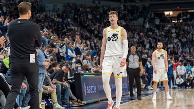Utah Jazz forward Kyle Filipowski (22) fouls out and walks past Utah Jazz head coach Will Hardy as he heads to the bench in t