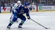 Feb 8, 2025; Vancouver, British Columbia, CAN; Vancouver Canucks forward Drew O'Connor (18) handles the puck against the Toronto Maple Leafs in the first period at Rogers Arena. Mandatory Credit: Bob Frid-Imagn Images