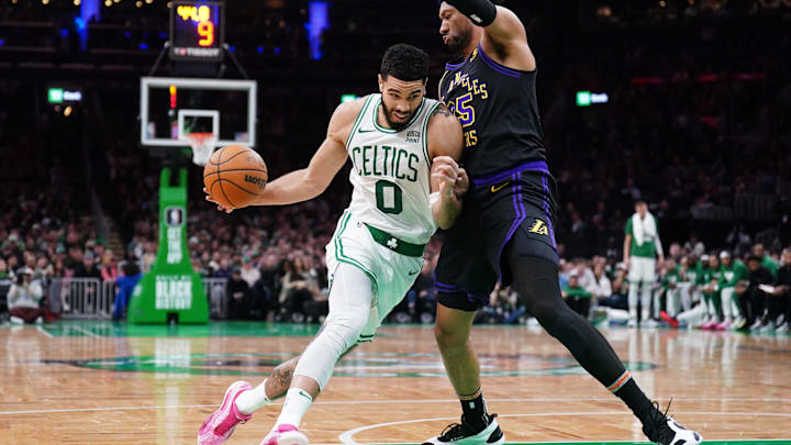 Feb 1, 2024; Boston, Massachusetts, USA; Boston Celtics forward Jayson Tatum (0) drives the ball against Los Angeles Lakers forward Christian Wood (35) in the second half at TD Garden. Mandatory Credit: David Butler II-Imagn Images