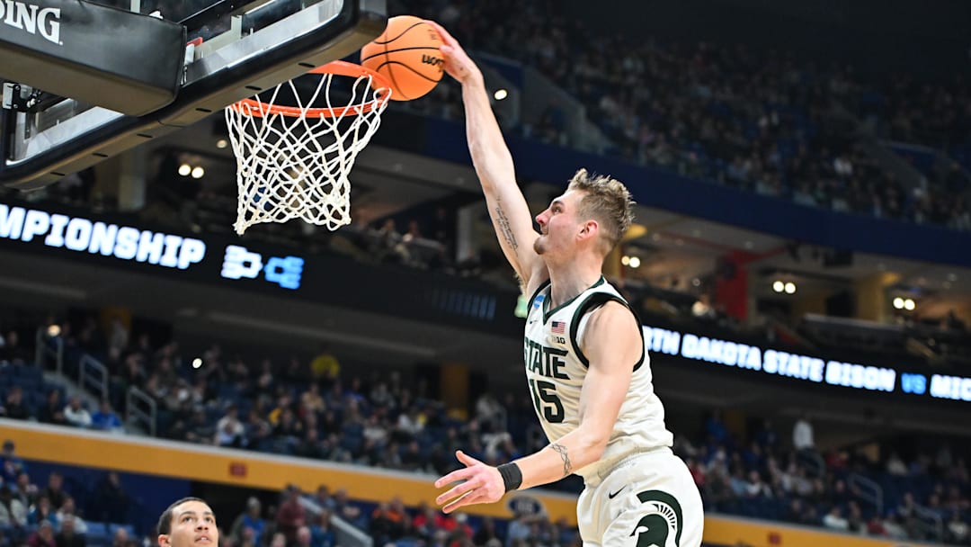 Mar 19, 2026; Buffalo, NY, USA; Michigan State Spartans center Carson Cooper (15) dunks during the second half against the North Dakota State Bison during a first round game of the men's 2026 NCAA Tournament at Keybank Center. Mandatory Credit: Mark Konezny-Imagn Images