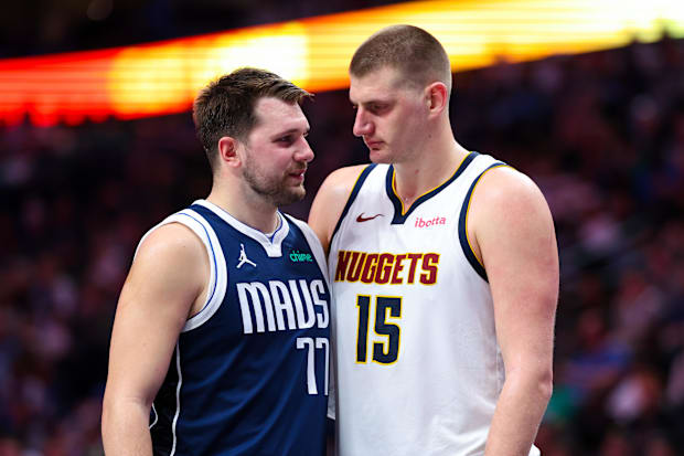 Dallas Mavericks guard Luka Doncic (77) speaks with Denver Nuggets center Nikola Jokic (15) Dallas Mavericks guard Luka Doncic (77) speaks with Denver Nuggets center Nikola Jokic (15)