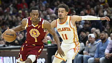 Apr 15, 2022; Cleveland, Ohio, USA; Atlanta Hawks guard Trae Young (11) defends Cleveland Cavaliers guard Rajon Rondo (1) in the third quarter at Rocket Mortgage FieldHouse. Mandatory Credit: David Richard-Imagn Images