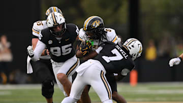 Oct 25, 2025; Nashville, Tennessee, USA; Missouri Tigers wide receiver Joshua Manning (0) is tackled by Vanderbilt Commodores safety Marlen Sewell (7) during the third quarter at FirstBank Stadium. Mandatory Credit: Steve Roberts-Imagn Images