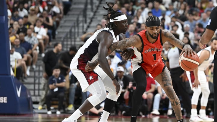 Jul 10, 2024; Las Vegas, Nevada, USA; USA guard Jrue Holiday (12) guards Canada guard Nickeil Alexander-Walker (1) in the second quarter in the USA Basketball Showcase at T-Mobile Arena. Mandatory Credit: Candice Ward-USA TODAY Sports