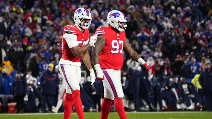 Buffalo Bills defensive end Greg Rousseau points to defensive tackle Zion Logue for making a play against the New England Patriots during the second half at Highmark Stadium.