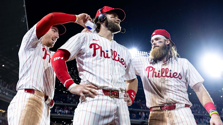 Philadelphia Phillies first baseman Bryce Harper celebrates with Bryson Stottand Brandon Marsh