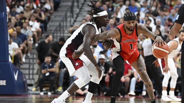 Jul 10, 2024; Las Vegas, Nevada, USA; USA guard Jrue Holiday (12) guards Canada guard Nickeil Alexander-Walker (1) in the second quarter in the USA Basketball Showcase at T-Mobile Arena. Mandatory Credit: Candice Ward-USA TODAY Sports