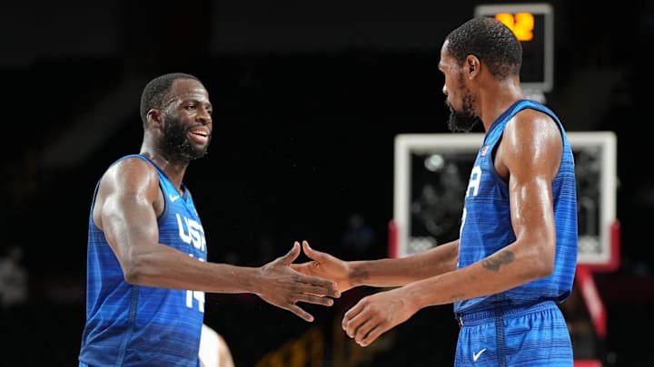 Team USA's Draymond Green and Kevin Durant high five during an Olympic match in 2021. Team USA's Draymond Green and Kevin Durant high five during an Olympic match in 2021.