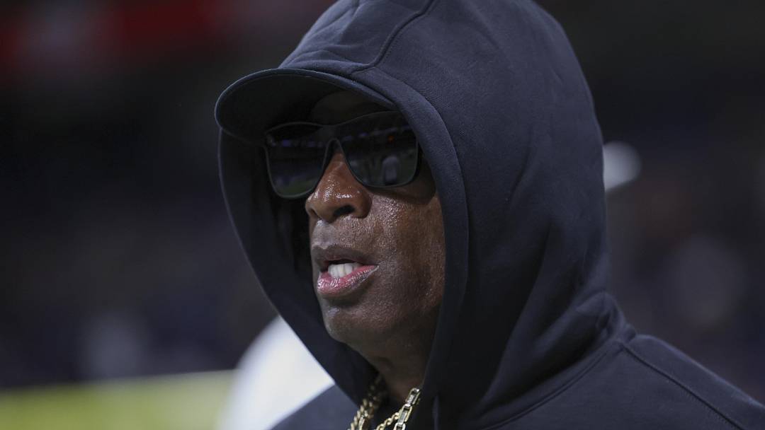 Dec 28, 2024; San Antonio, TX, USA; Colorado Buffaloes head coach Deion Sanders jogs on the field before the game against the Brigham Young Cougars at Alamodome. 