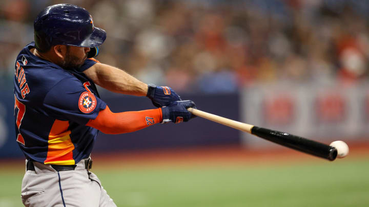 Aug 12, 2024; St. Petersburg, Florida, USA; Houston Astros second baseman Jose Altuve (27) hits a single against the Tampa Bay Rays in the third inning at Tropicana Field