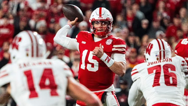 Nov 23, 2024; Lincoln, Nebraska, USA; Nebraska Cornhuskers quarterback Dylan Raiola (15) passes against Wisconsin Badgers defensive lineman Dillan Johnson (76) during the fourth quarter at Memorial Stadium. Mandatory Credit: Dylan Widger-Imagn Images