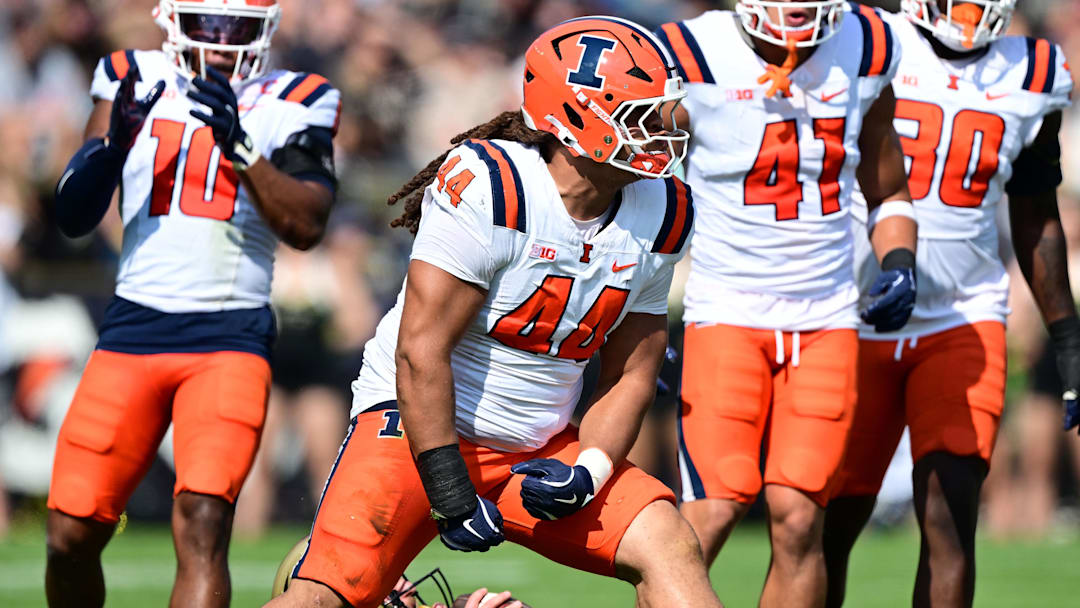 Illinois Fighting Illini defensive lineman Angelo McCullom celebrates sacking Purdue Boilermakers quarterback Ryan Browne
