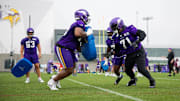 Christian Darrisaw practices with over Vikings offensive linemen at minicamp.