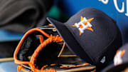 Apr 27, 2025; Kansas City, Missouri, USA; Houston Astros hat and glove in the dugout during the second inning against the Kansas City Royals at Kauffman Stadium. 