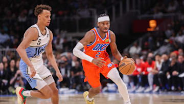 Feb 28, 2025; Atlanta, Georgia, USA; Oklahoma City Thunder guard Shai Gilgeous-Alexander (2) drives past Atlanta Hawks guard Dyson Daniels (5) in the second quarter at State Farm Arena. Mandatory Credit: Brett Davis-Imagn Images
