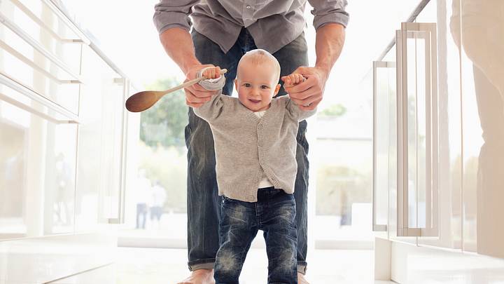 Father helping son learn to walk