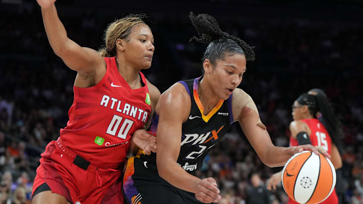 Jul 23, 2025; Phoenix, Arizona, USA; Phoenix Mercury forward Alyssa Thomas (25) drives on Atlanta Dream forward Naz Hillmon (0) in the second half at Footprint Center. Mandatory Credit: Rick Scuteri-Imagn Images