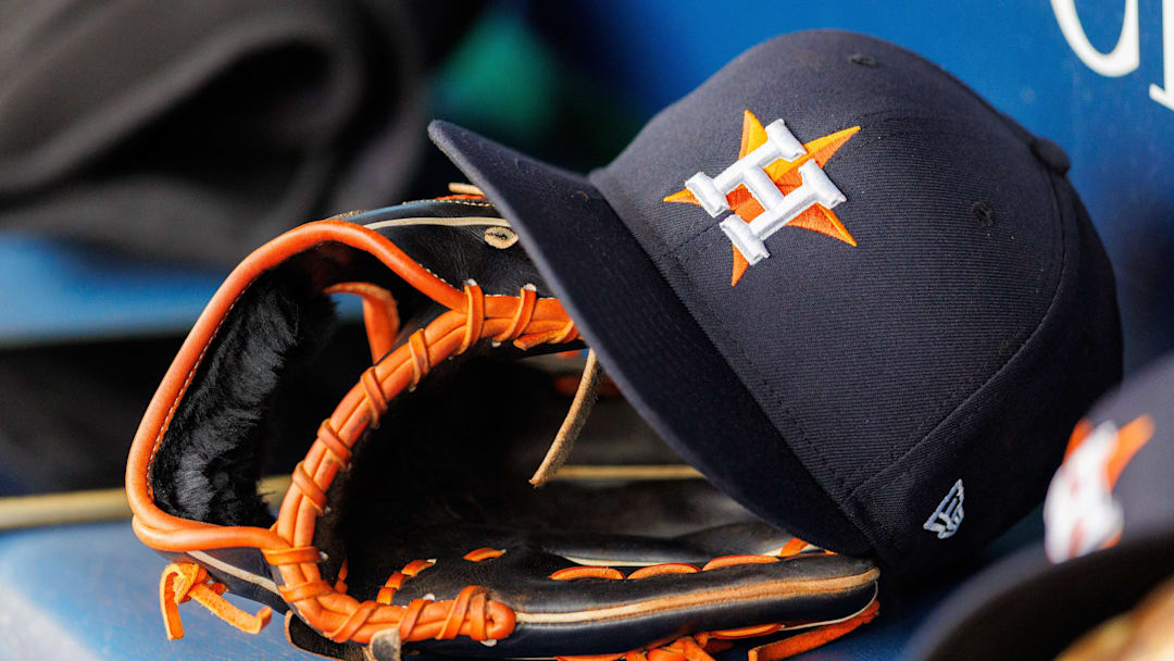 Apr 27, 2025; Kansas City, Missouri, USA; Houston Astros hat and glove in the dugout during the second inning against the Kansas City Royals at Kauffman Stadium.