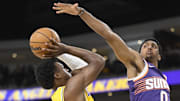 Oct 3, 2025; Palm Desert, California, USA; Los Angeles Lakers guard Bronny James (9) tries to shoot past Phoenix Suns forward Ryan Dunn (0) during the first half at Acrisure Arena. Mandatory Credit: Denis Poroy-Imagn Images