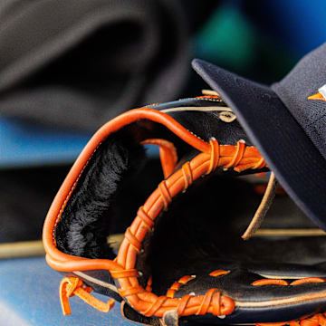 Apr 27, 2025; Kansas City, Missouri, USA; Houston Astros hat and glove in the dugout during the second inning against the Kansas City Royals at Kauffman Stadium. Mandatory Credit: William Purnell-Imagn Images