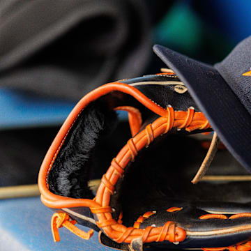 Apr 27, 2025; Kansas City, Missouri, USA; Houston Astros hat and glove in the dugout during the second inning against the Kansas City Royals at Kauffman Stadium. Mandatory Credit: William Purnell-Imagn Images