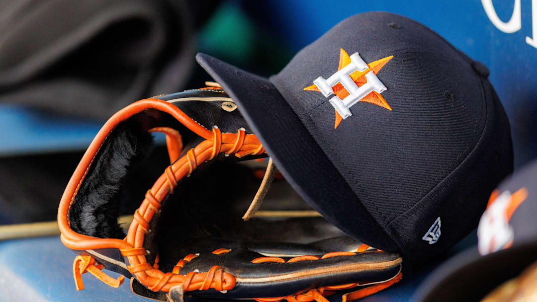Apr 27, 2025; Kansas City, Missouri, USA; Houston Astros hat and glove in the dugout during the second inning against the Kansas City Royals at Kauffman Stadium. 