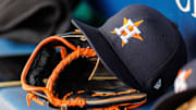 Houston Astros hat and glove in the dugout during the second inning against the Kansas City Royals at Kauffman Stadium.