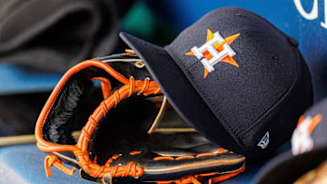 Apr 27, 2025; Kansas City, Missouri, USA; Houston Astros hat and glove in the dugout during the second inning against the Kansas City Royals at Kauffman Stadium. 
