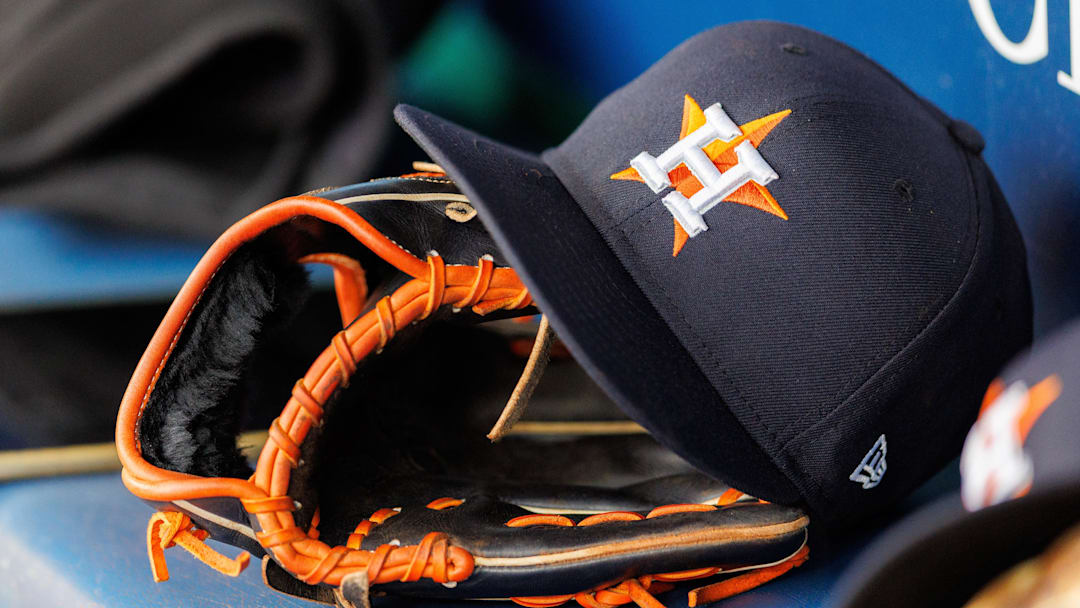 Apr 27, 2025; Kansas City, Missouri, USA; Houston Astros hat and glove in the dugout during the second inning against the Kansas City Royals at Kauffman Stadium. 